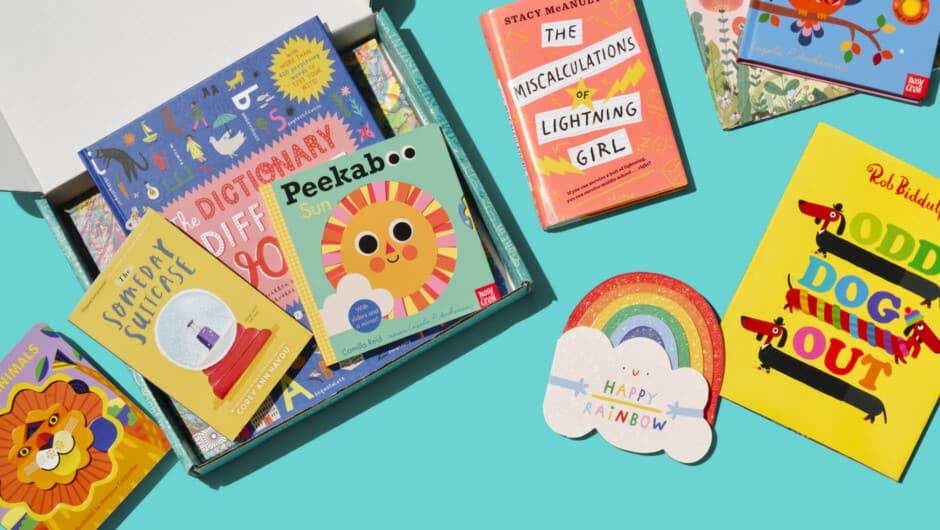 Overhead image of open Literati box with books inside and stacked outside for all ages.