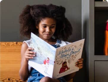 A young girl reads a book.