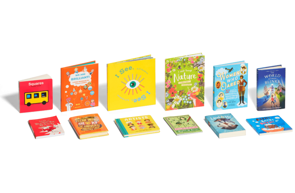 Rainbow arrangement of books standing and laying down for all ages.